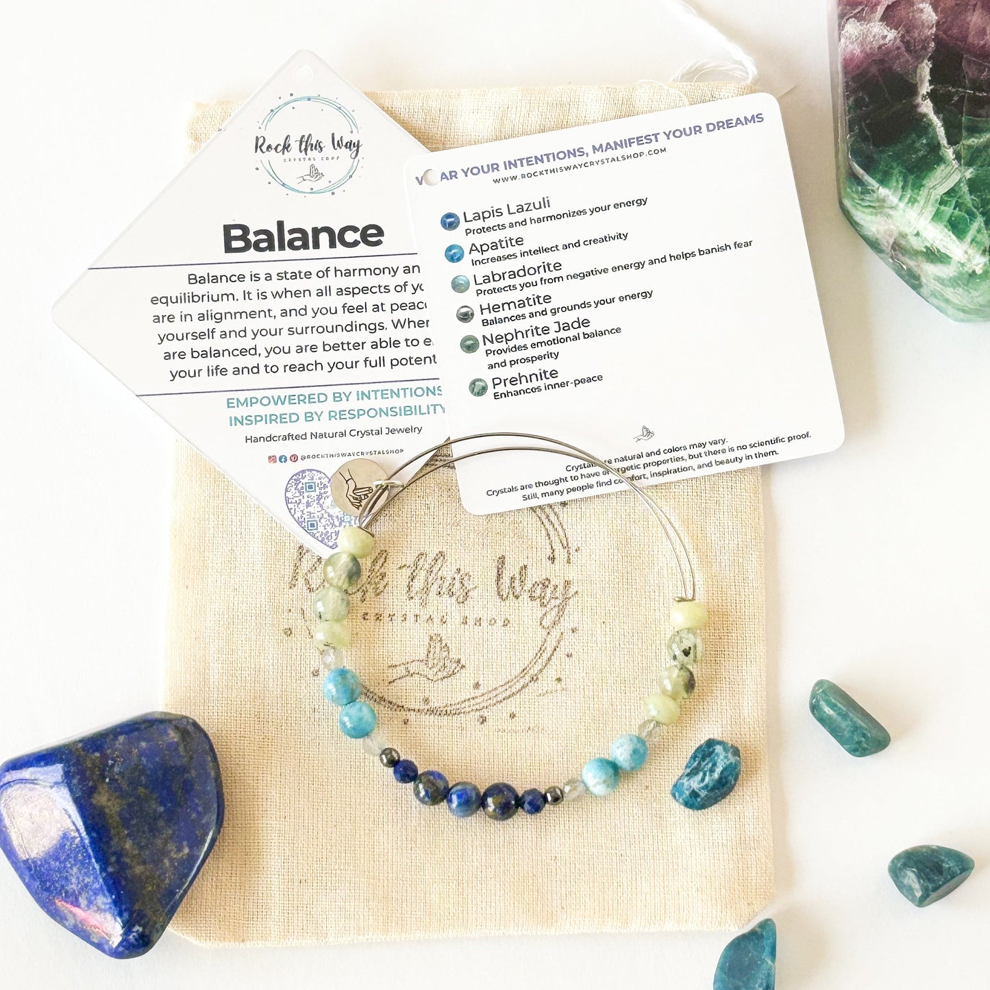 Balance bangle flay lay with packaging and crystals
