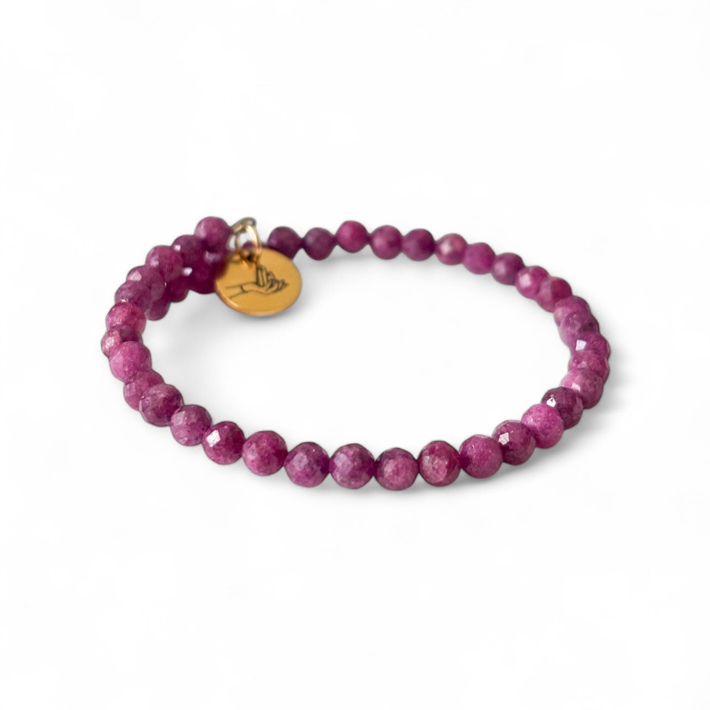 Ruby wrap bracelet laid flat, highlighting 4mm micro-faceted beads and wrap style.