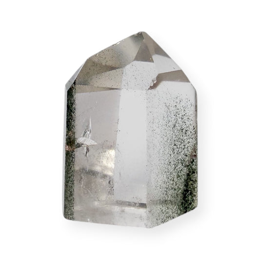 Clear crystal tower with natural green chlorite inclusion on a white background