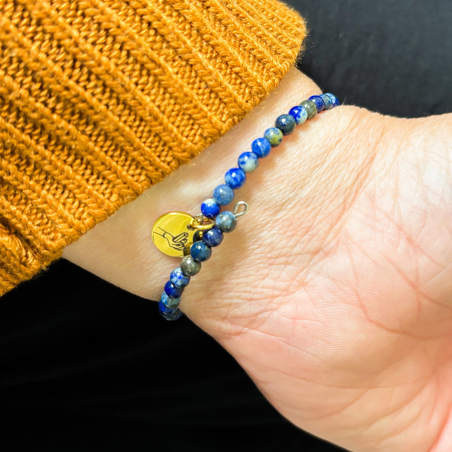 Lapis Lazuli bracelet wrapped on wrist, styled with neutral outfit