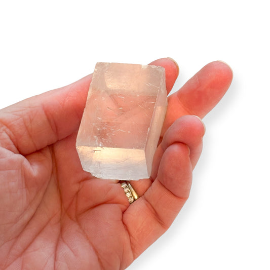 Medium Optical Calcite crystal held in hand showing size and clarity