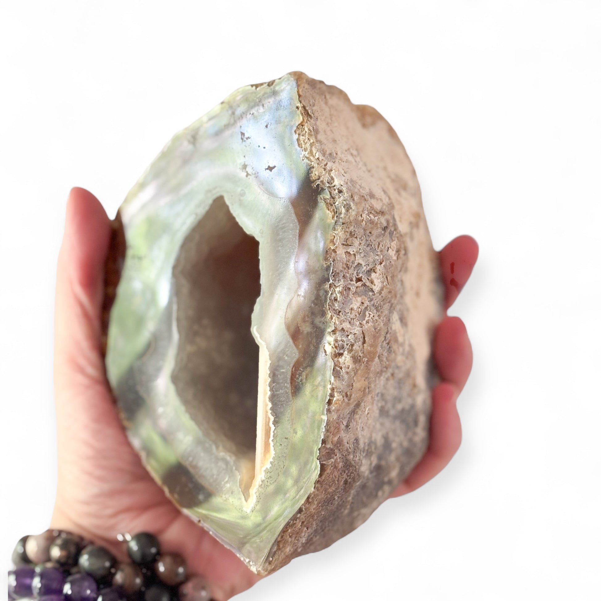 Crystal shown in hand for scale and connection