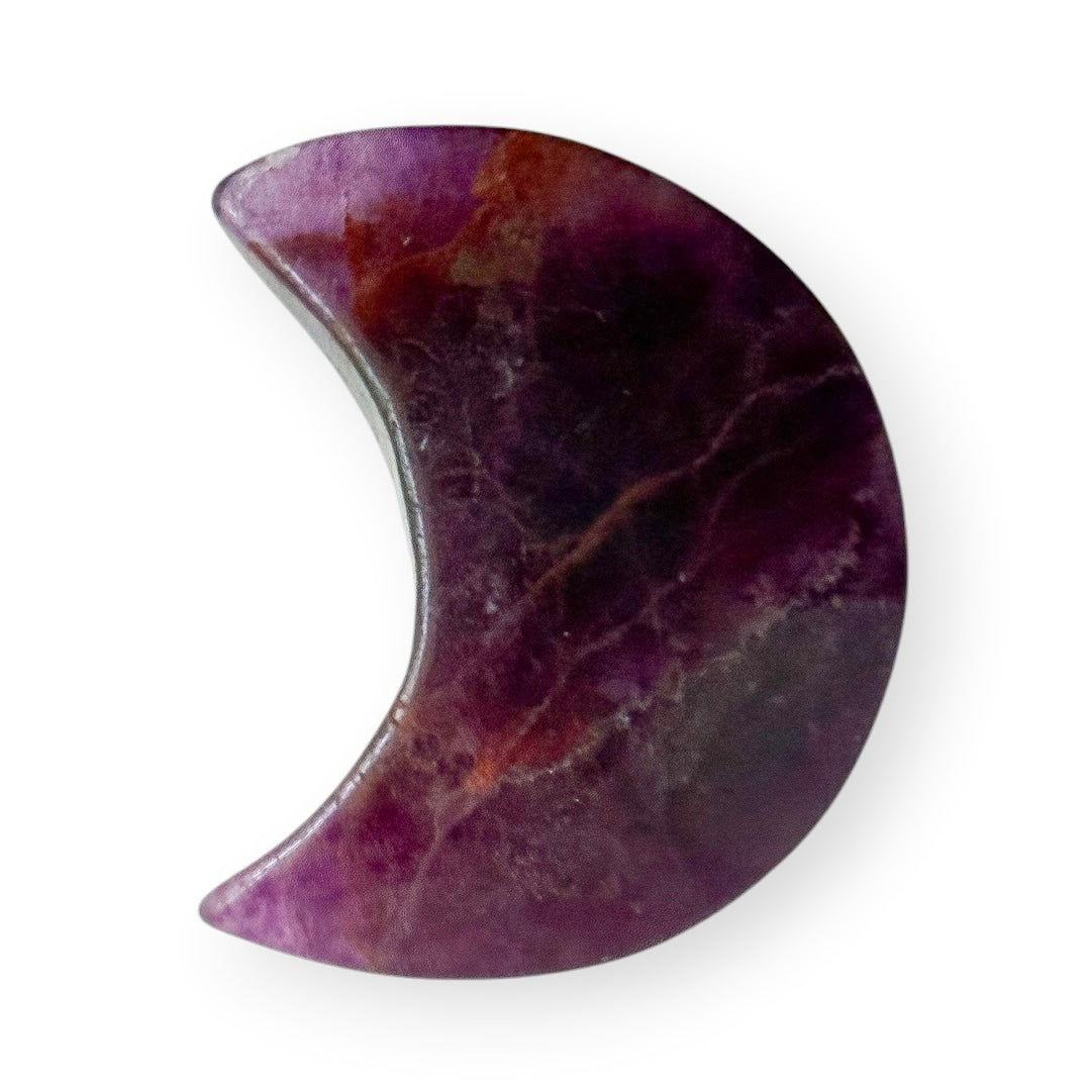Side profile of a polished rainbow fluorite crescent moon crystal carving with rich purple coloration.