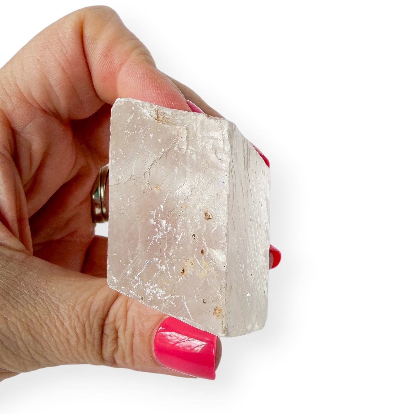 Translucent optical calcite in hand showing side angle