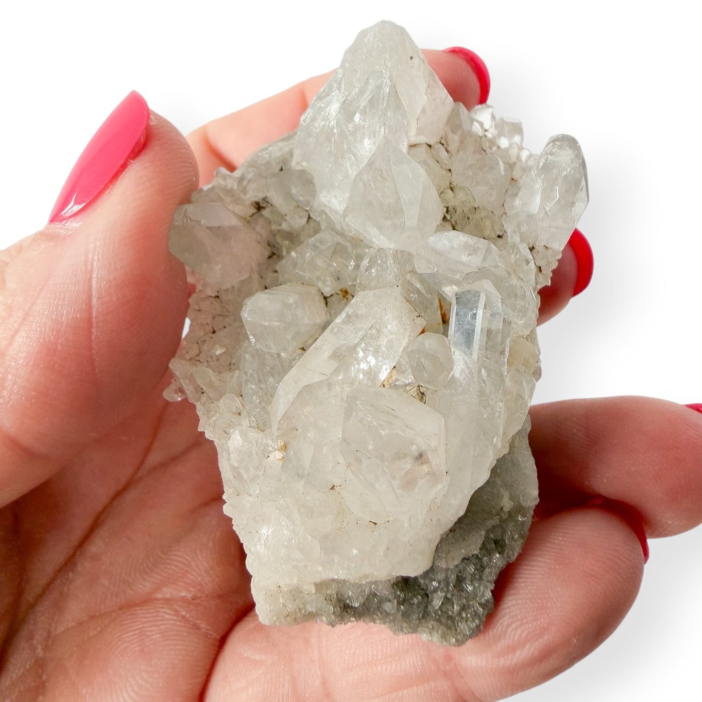 Hand holding a crystal cluster with a white background