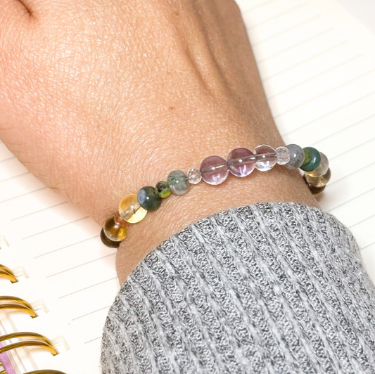 Writing in a journal while wearing the success bracelet.