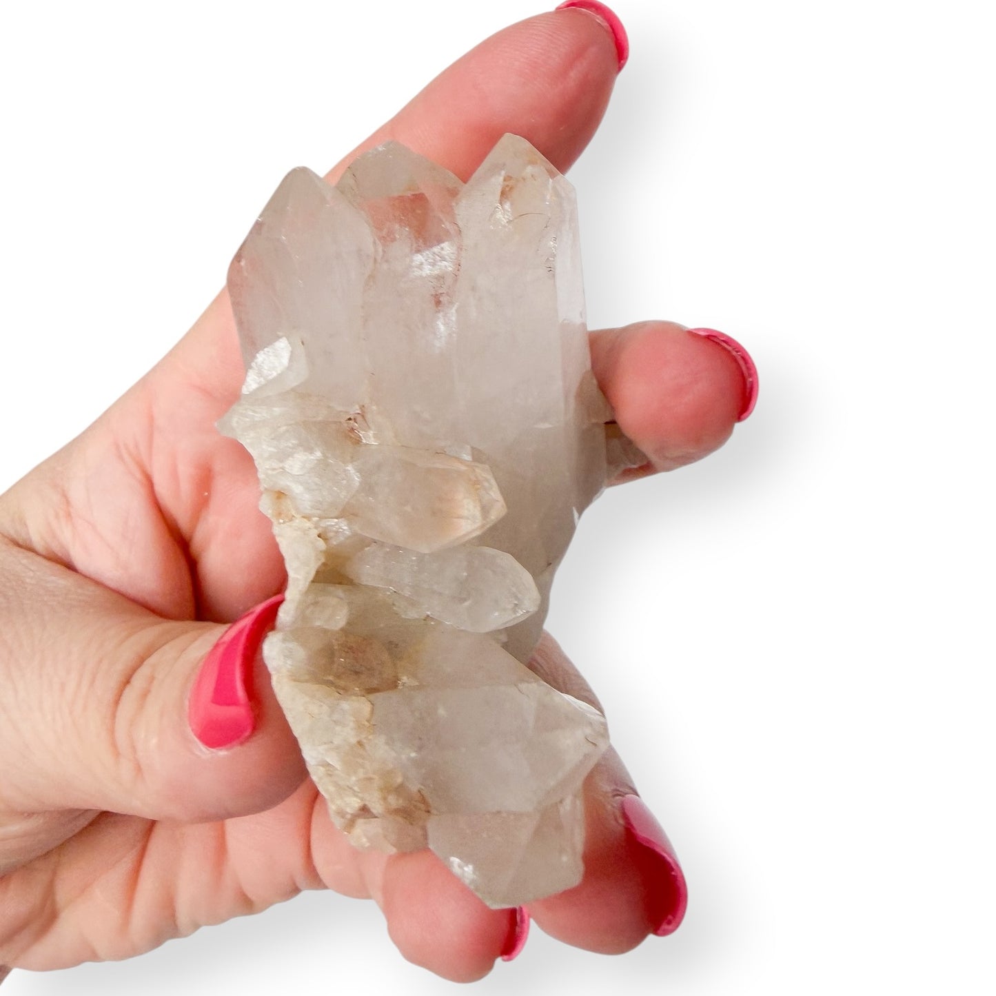 Hand holding a crystal with a white background