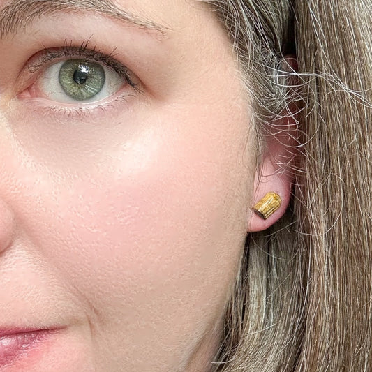 Tigers Eye studs hypoallergenic in ear of woman to show size