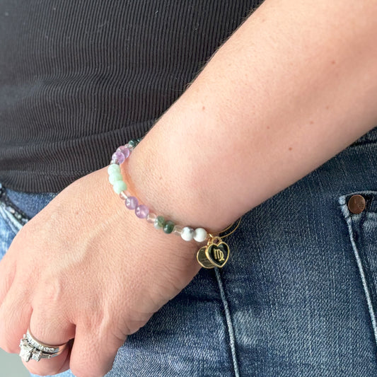 A person wearing the Virgo Bracelet with a Black Virgo Charm