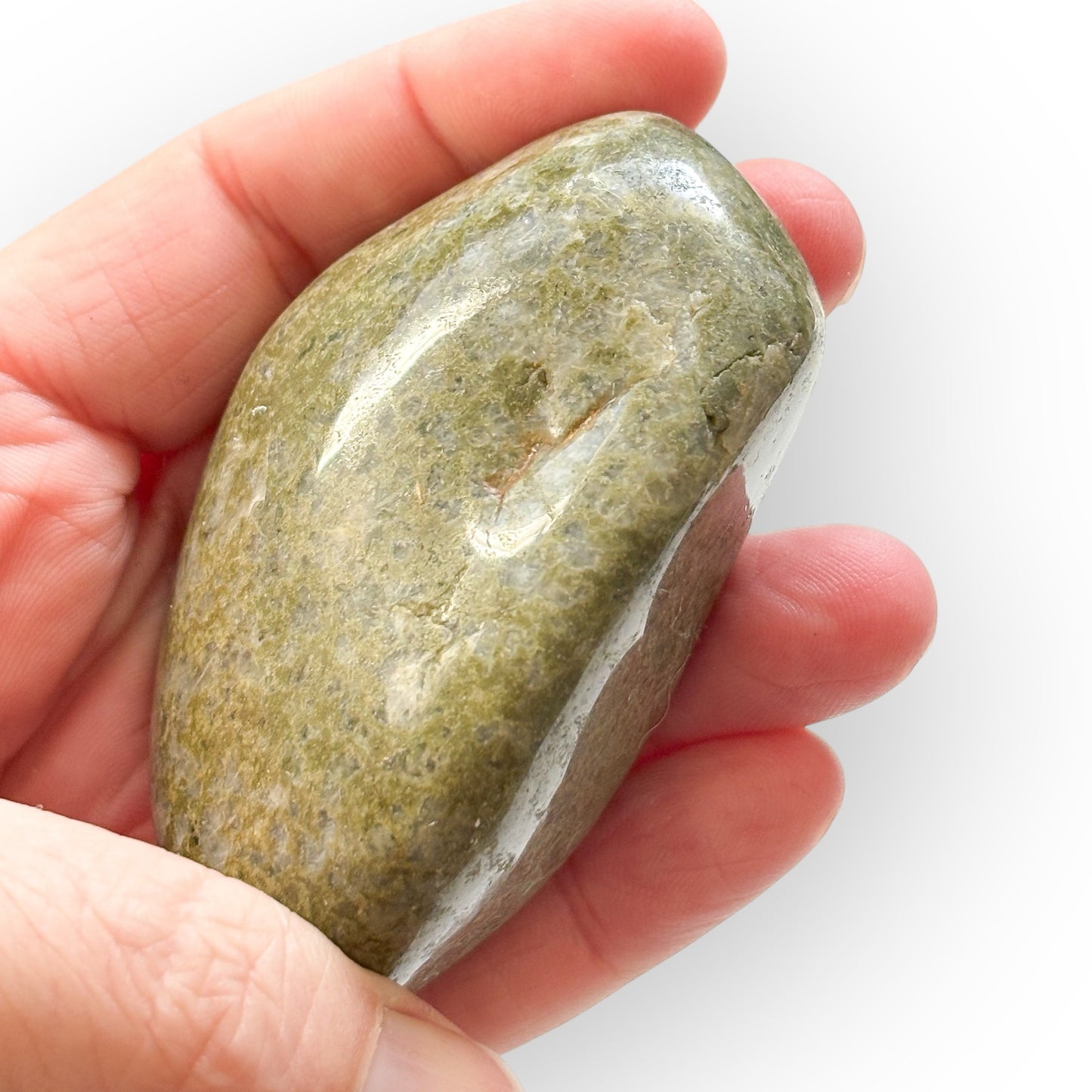 Hand holding medium African Epidote for size reference