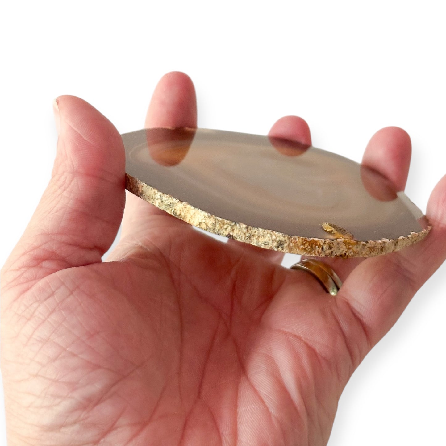 Agate slice catching light with subtle crystal texture