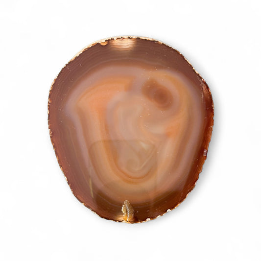 Close-up of agate slice showing soft orange and brown banding