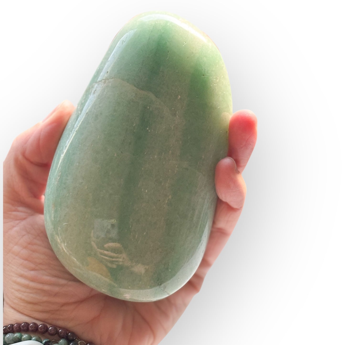 Hand holding large Amazonite stone to show scale and polished surface