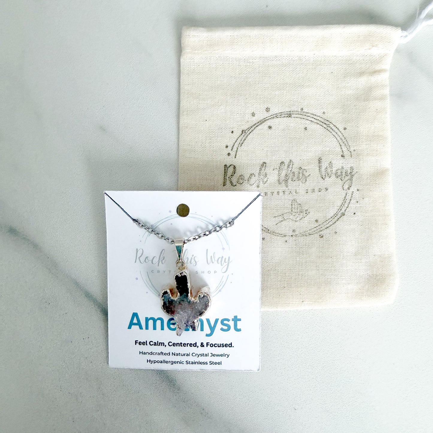 Amethyst cactus pendant necklace with silver plated setting displayed on Rock This Way Crystal Shop packaging.