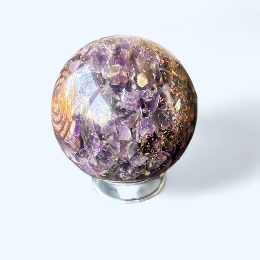 Close-up of Amethyst Orgone Sphere showing rich purple crystal chips and copper coil