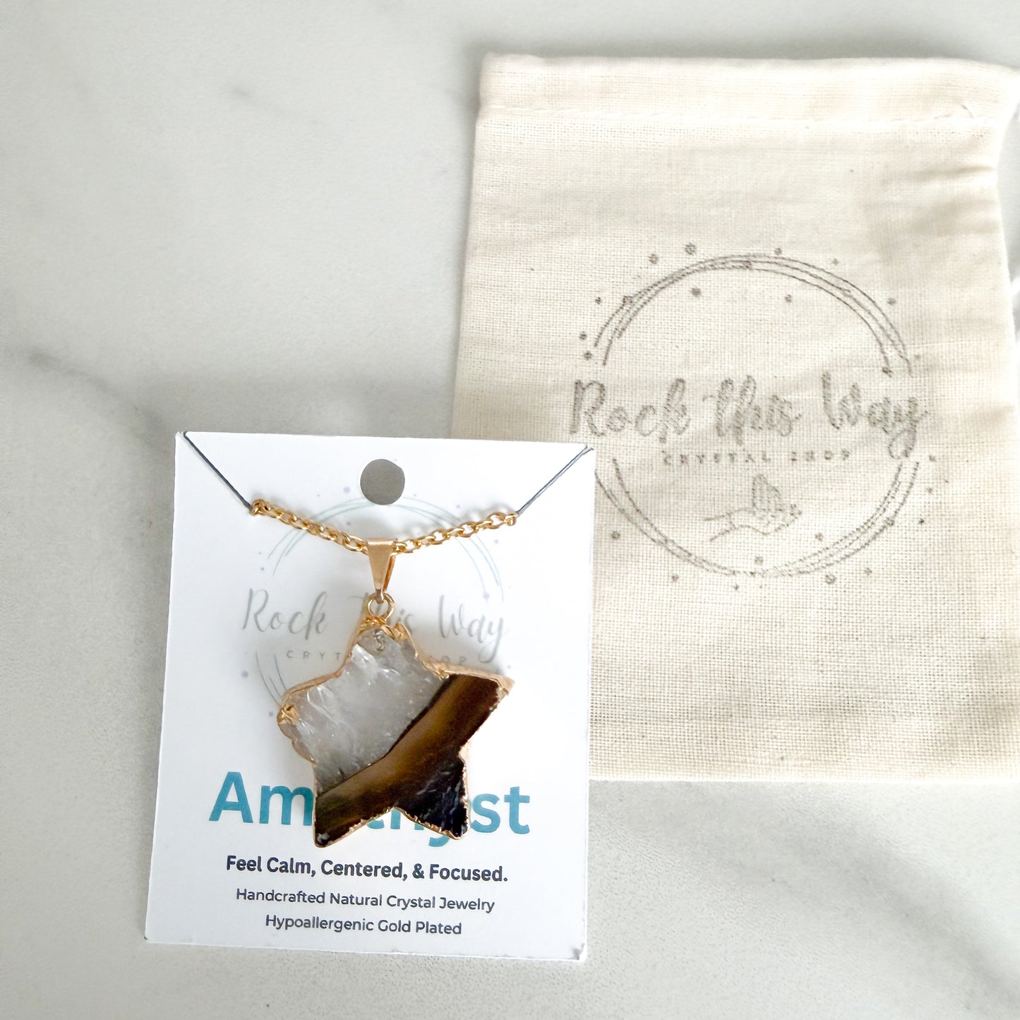 Gold plated amethyst star pendant necklace displayed on Rock This Way Crystal Shop packaging, ready for gifting.