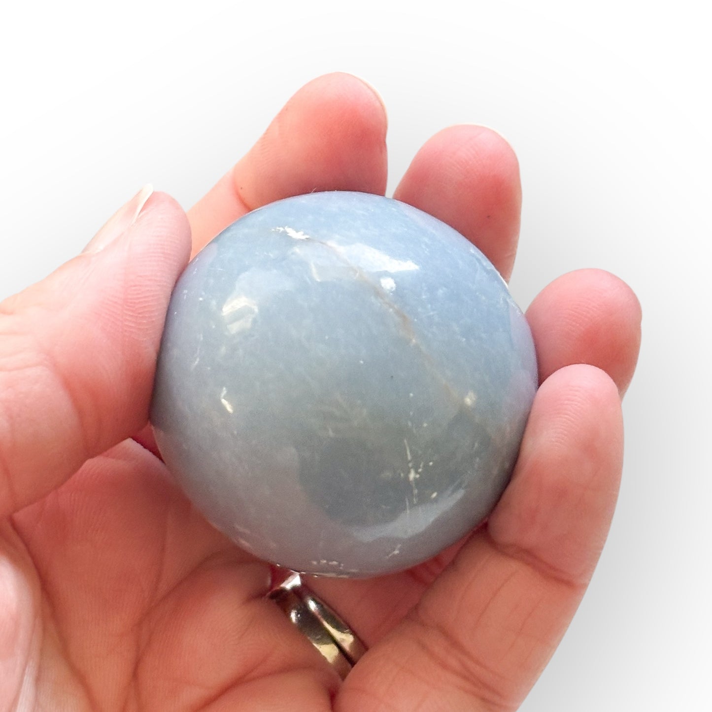 Angelite Sphere held in hand for size reference