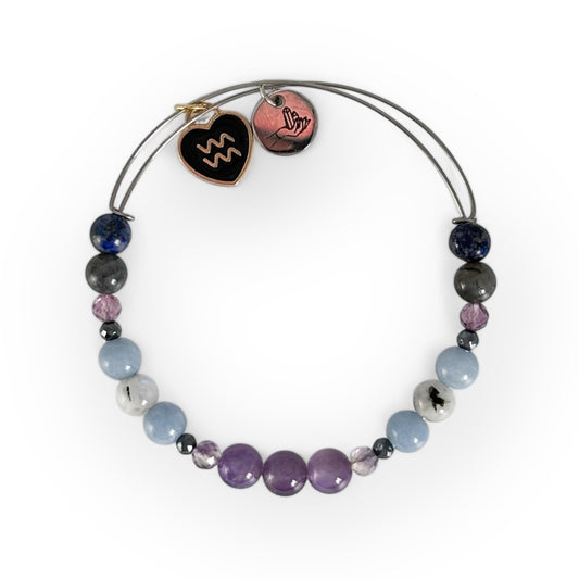 Aquarius Crystal Charm Bracelet with a black charm, featuring Amethyst, Fluorite, Angelite, Moonstone, Labradorite, and Lapis Lazuli for wisdom and clarity.