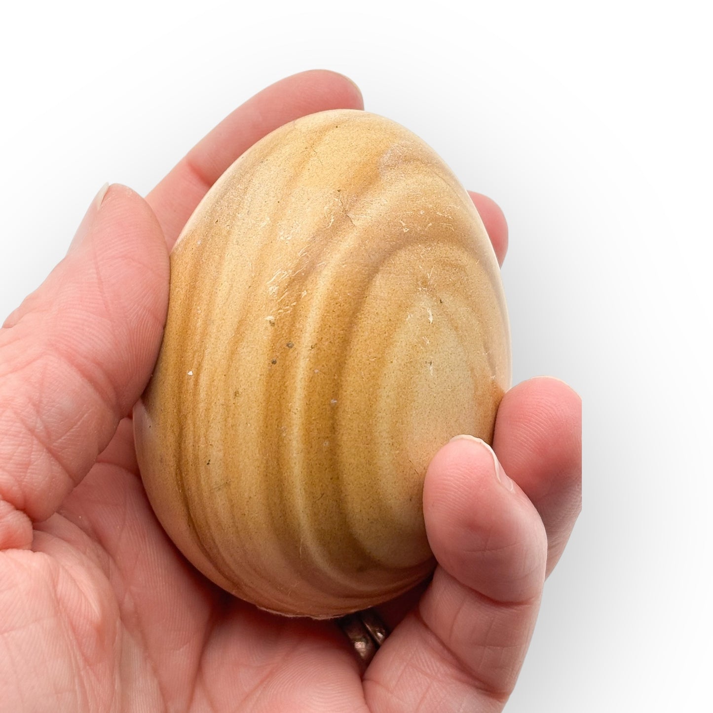 Close-up of Banded Onyx crystal egg showing detailed layers and smooth polish