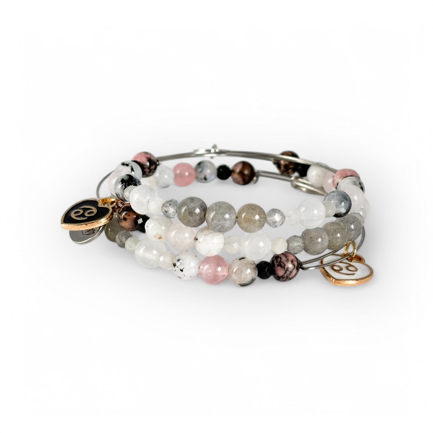 Cancer Crystal Charm Bracelet with a white charm stacked with other crystal bracelets for a layered, nurturing style.