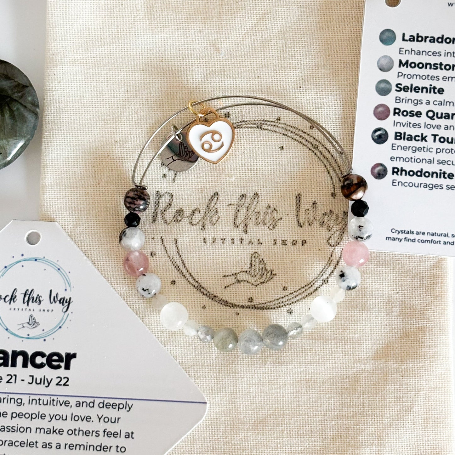 Cancer Crystal Charm Bracelet with a white charm displayed in Rock This Way Crystal Shop packaging, ready for gifting.