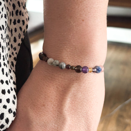 Capricorn Crystal Charm Bracelet with a white charm worn on wrist, highlighting its comfortable and adjustable fit.