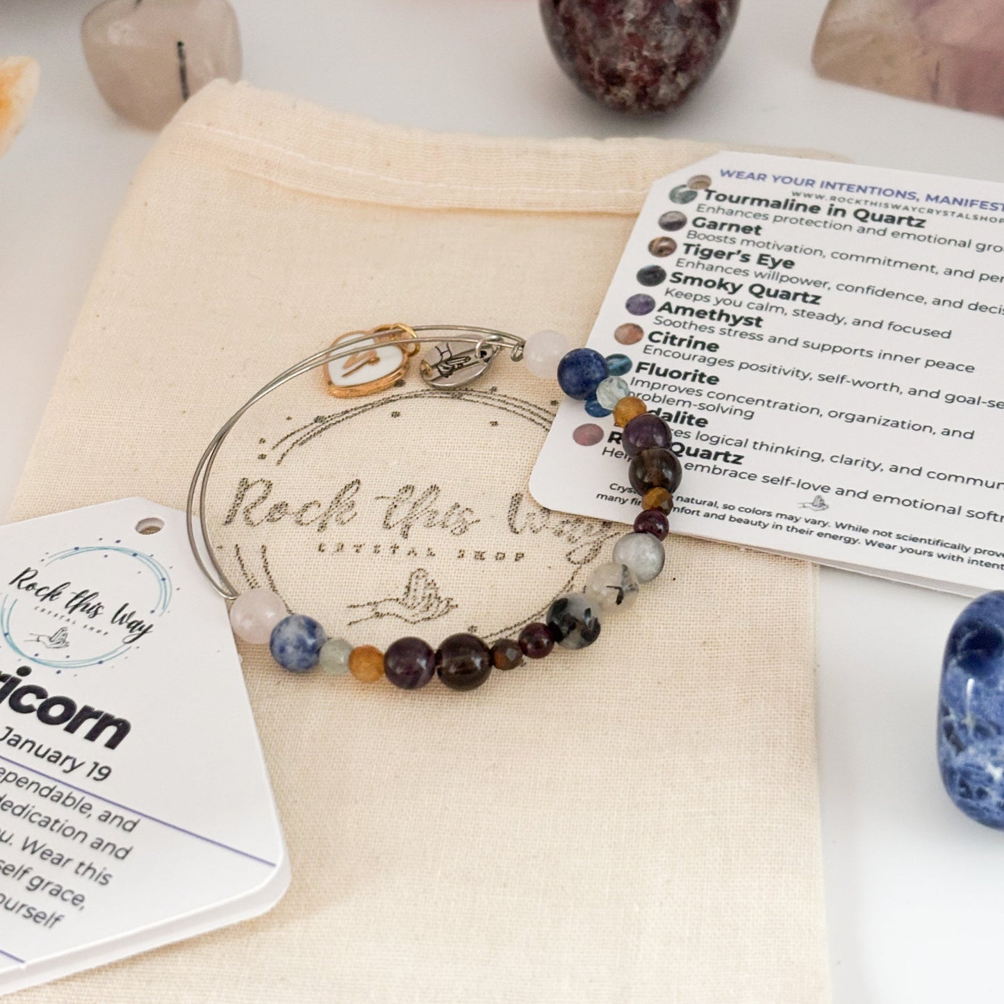 Capricorn Crystal Charm Bracelet with a white charm displayed in Rock This Way Crystal Shop packaging, ready for gifting.