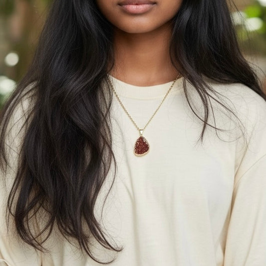 Modeled view of a gold plated citrine drusy cluster pendant necklace on a PVD gold plated stainless steel chain, shown in an AI generated lifestyle image.