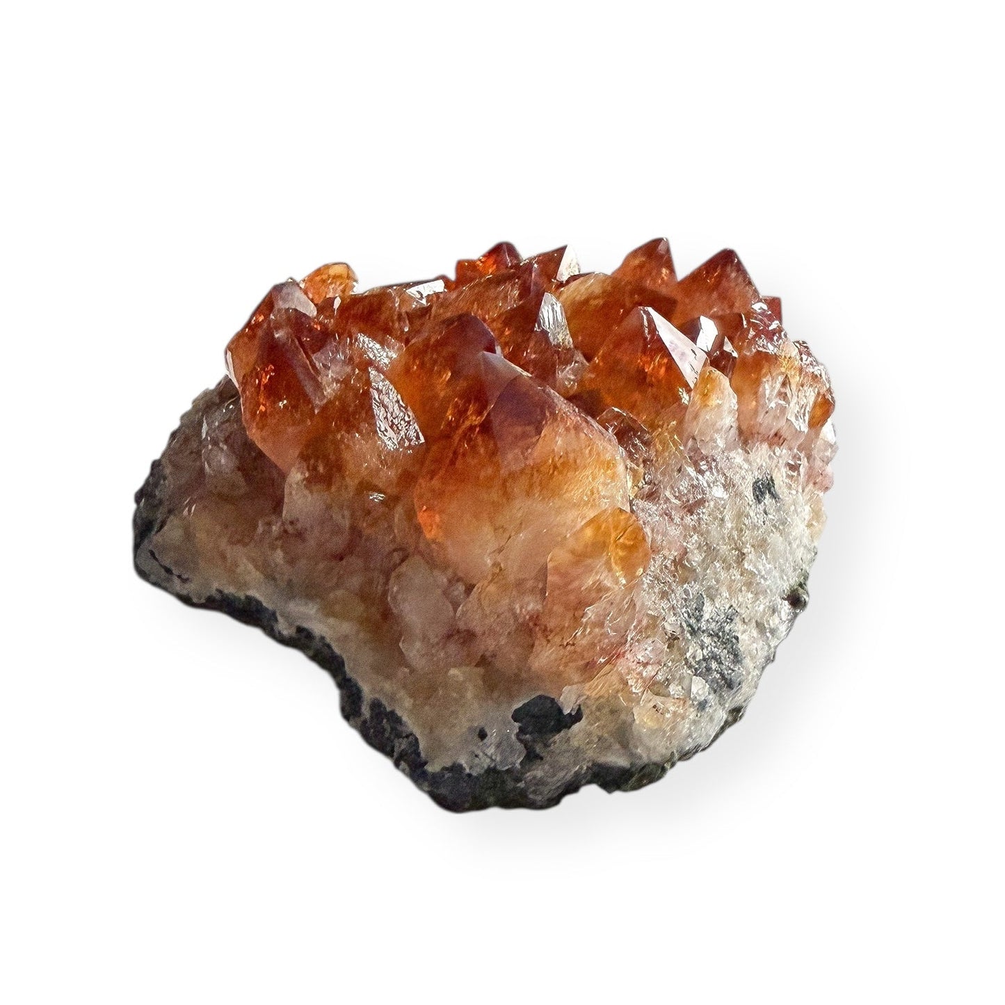 Side view of citrine crystal cluster showing raw matrix base and crystal points.