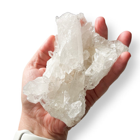 Clear Quartz crystal chunk with a rough, natural texture shown in hand for scale.