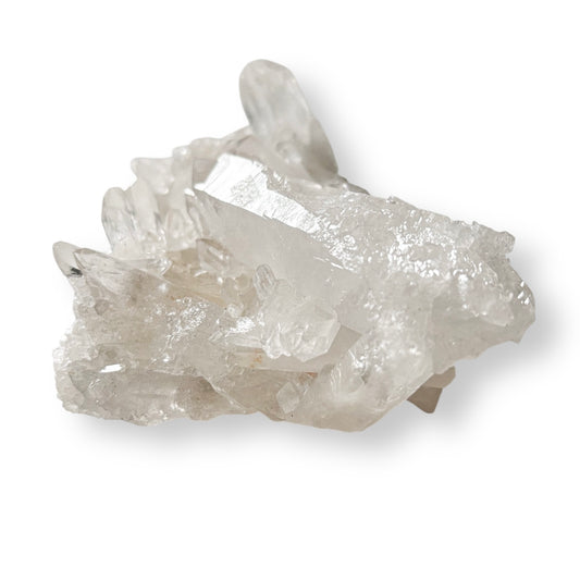 Raw Clear Quartz cluster with sharply defined points and bright, icy tones.