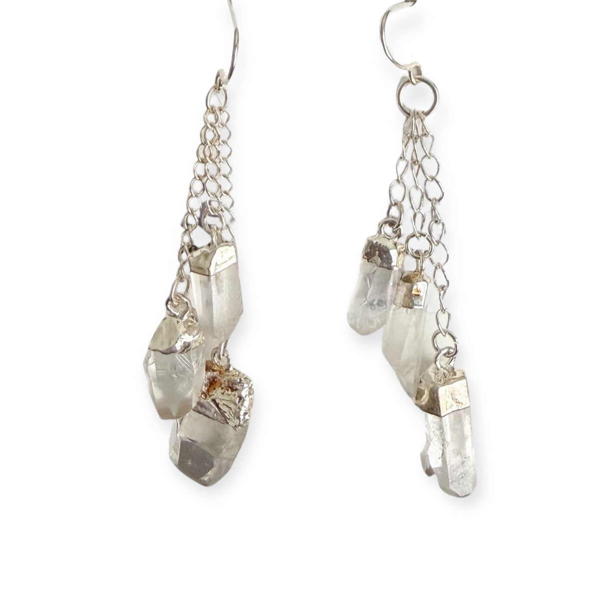 Clear quartz dangle earrings with silver plated hardware on a white background, featuring natural crystal stones and a 2.5 inch drop