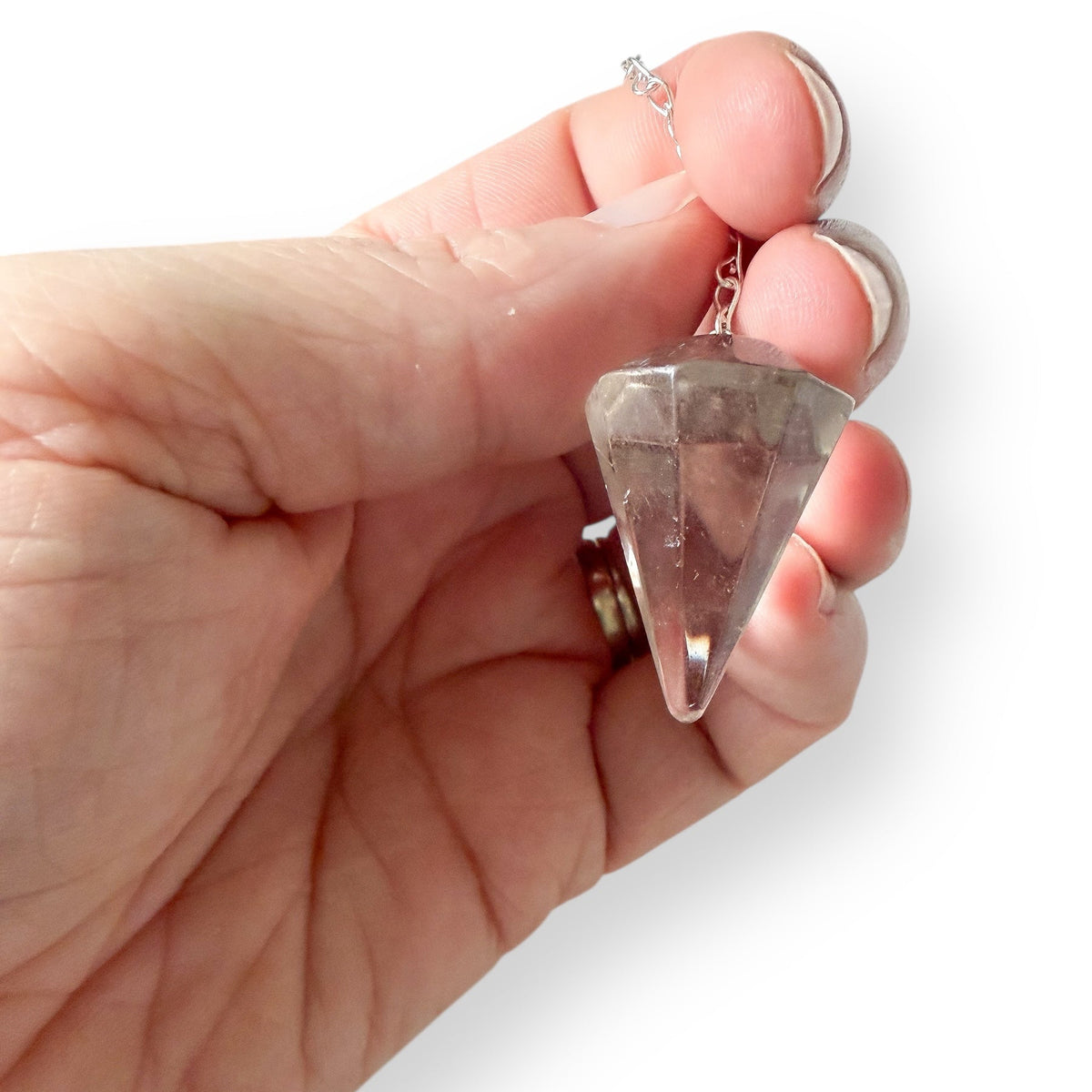 Close up of clear quartz pendulum metaphysical tool showing natural crystal details