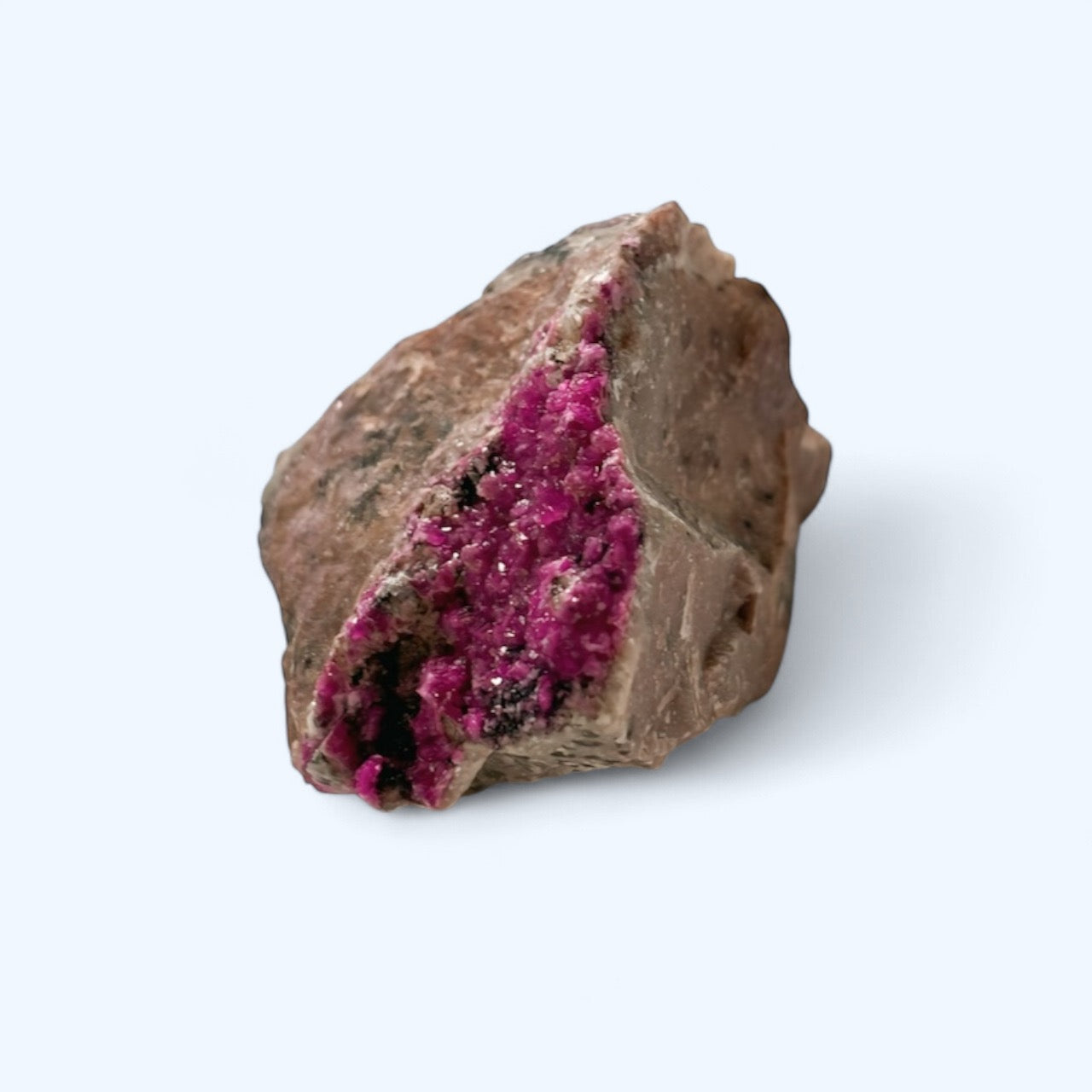 Side angle of raw Cobalto Calcite showing earthy stone base and pink crystal formation
