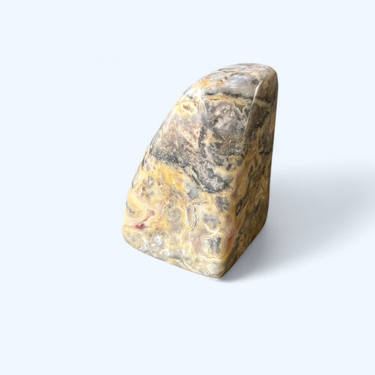 Side angle of Crazy Lace Agate showing unique patterns and soft polish