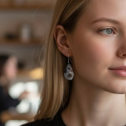 Dark geode drusy earrings worn on model with sterling silver kidney ear wires and natural crystal texture