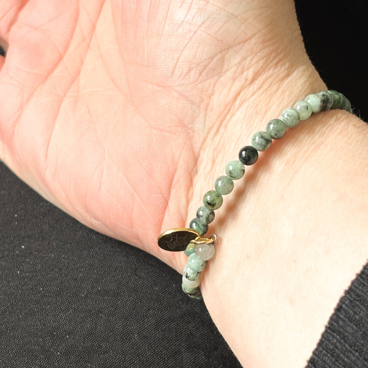 Close-up of Emerald wrap bracelet showcasing its vibrant green polished beads.
