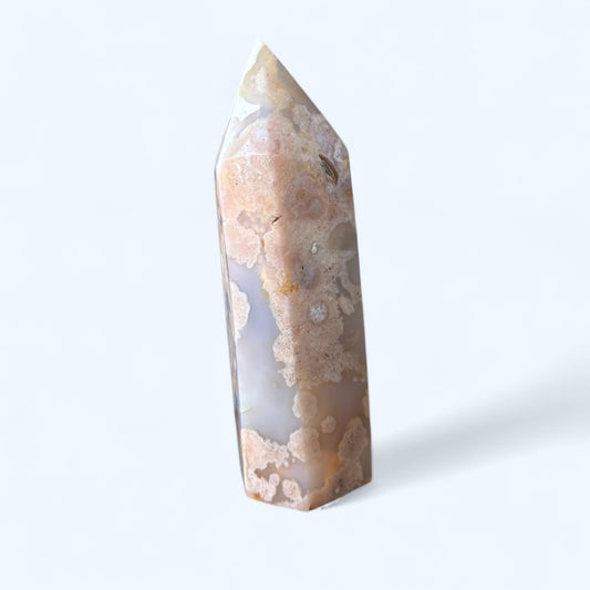 Side angle of Flower Agate tower showing floral-like patterns and soft neutral colors