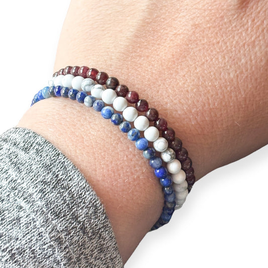 Person wearing the Freedom Stack on wrist with Garnet, Howlite, and Lapis wrap bracelets