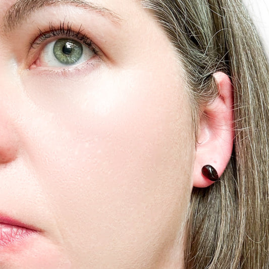 Front view of handcrafted Garnet stud earrings on stainless steel posts