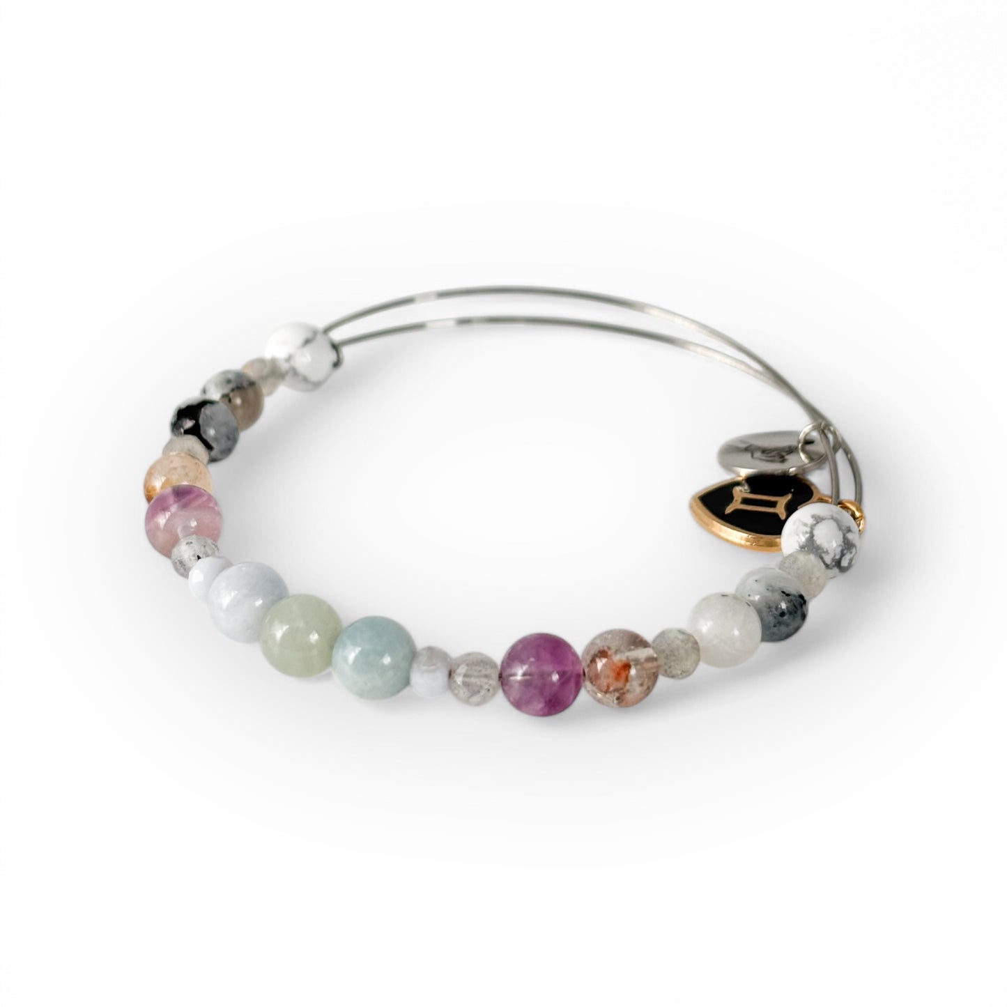 Close-up of Gemini Crystal Charm Bracelet with a black charm, showcasing its polished and diverse gemstone hues.