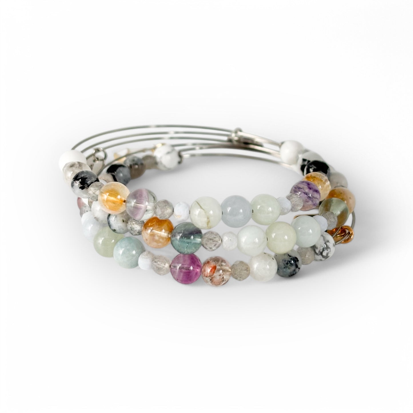 Gemini Crystal Charm Bracelet with a black charm stacked with other bracelets for a lively and adaptable style.