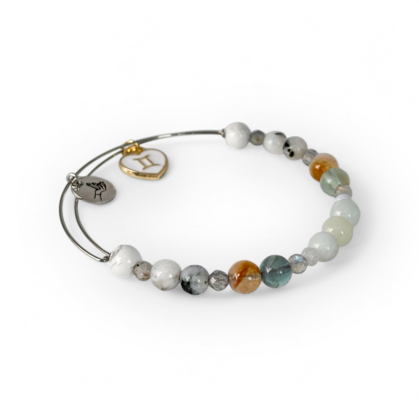 Close-up of Gemini Crystal Charm Bracelet with a white charm, showcasing its vibrant and airy gemstone beads.