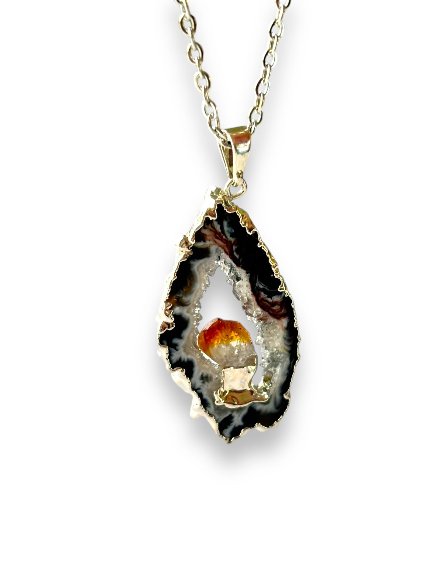 Dark agate geode pendant with citrine crystal center on gold-plated chain