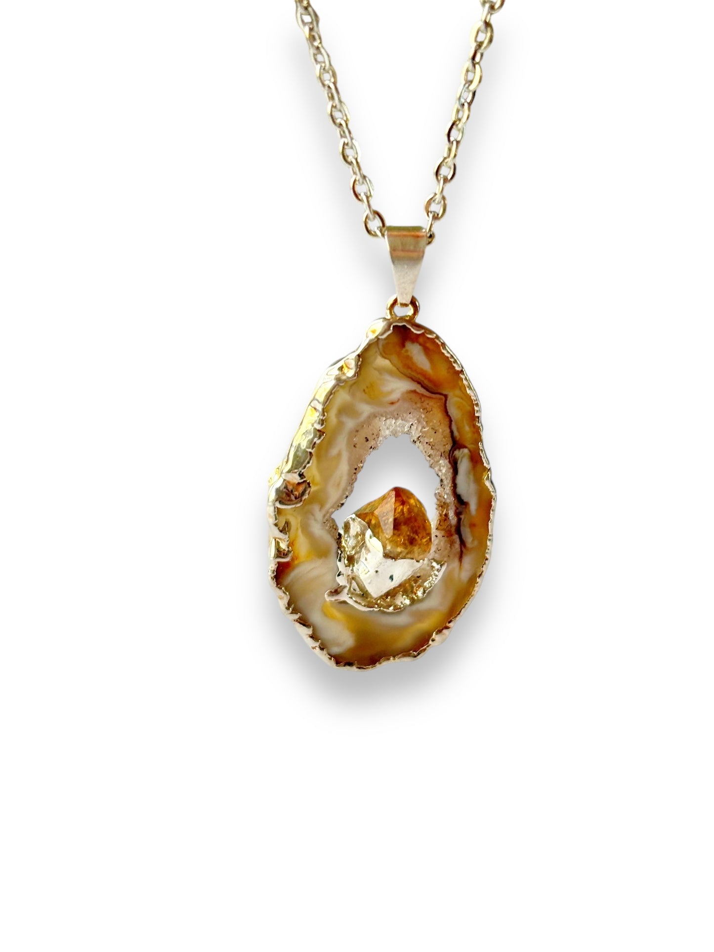 Warm brown and amber-toned geode slice with raw citrine center on stainless steel chain