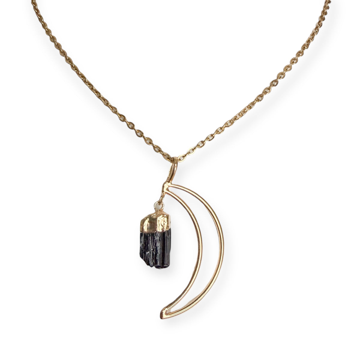 Gold plated crescent moon pendant necklace with natural black tourmaline crystal on a PVD gold plated stainless steel chain.