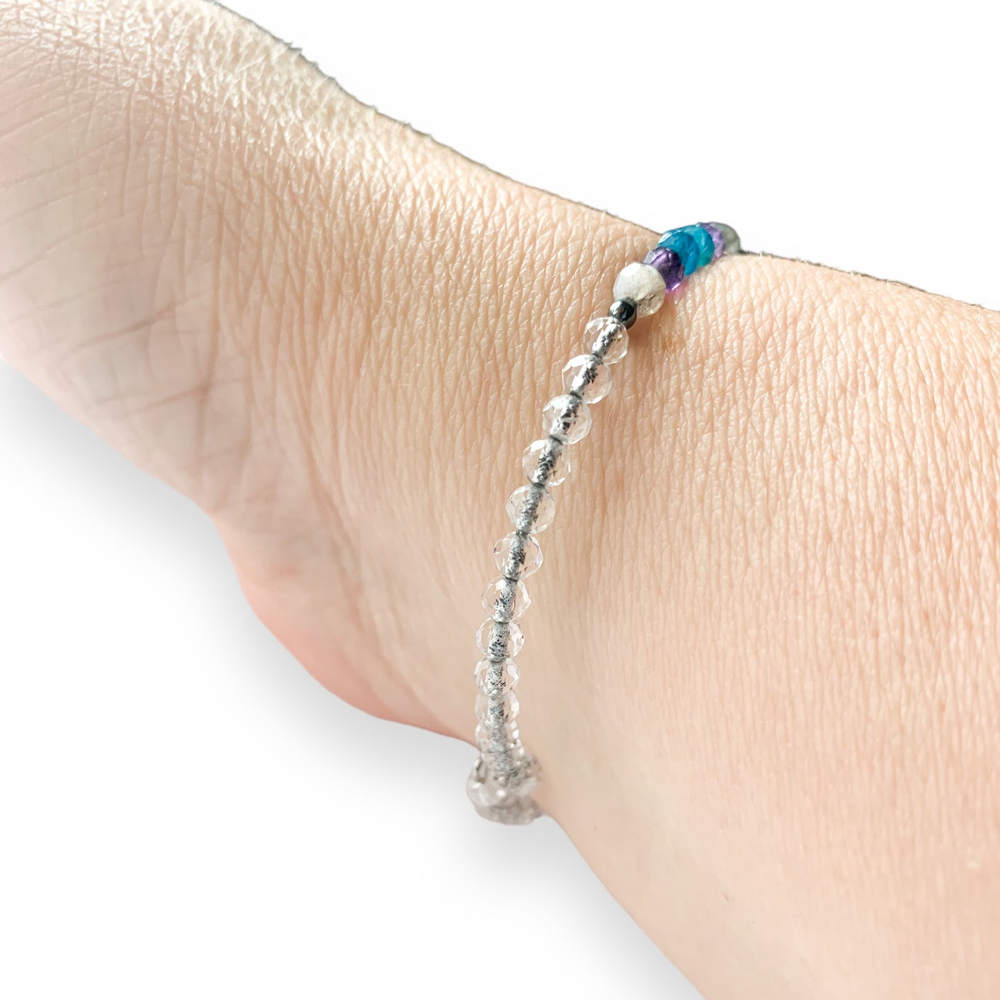 Intuition Crystal Wrap Bracelet stacked on wrist, flexible stainless steel band for easy everyday wear.