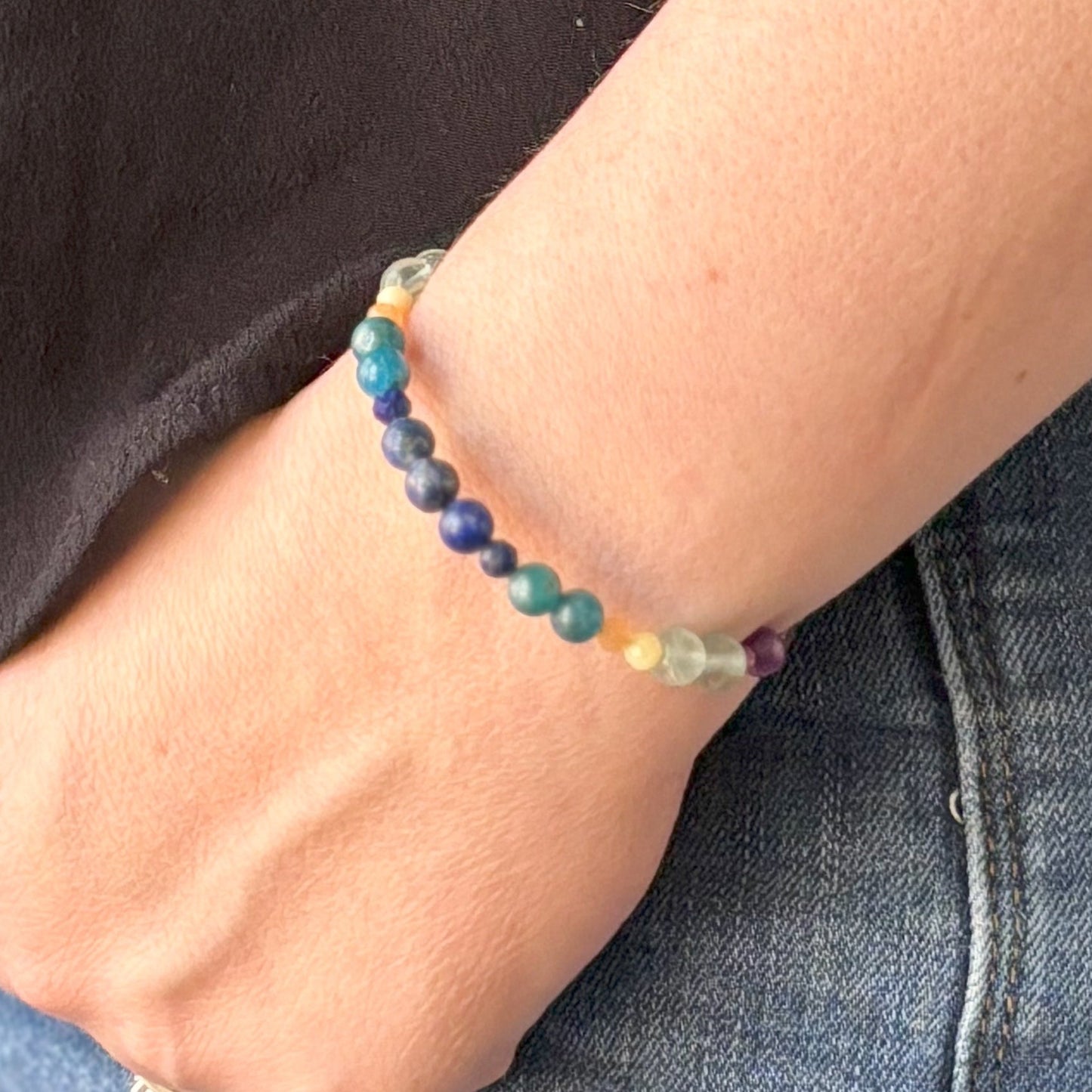Joy intention bracelet shown on wrist with vibrant natural crystal beads