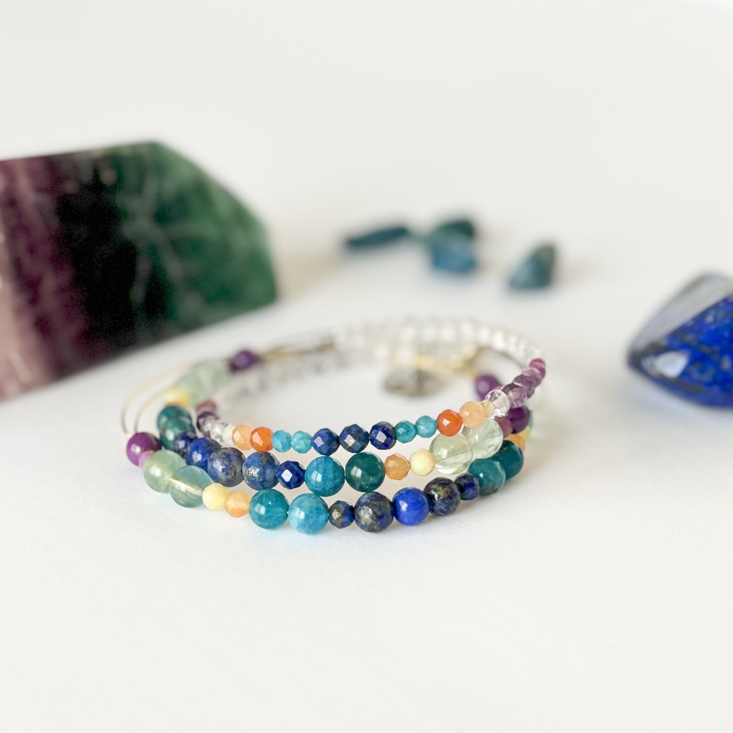 Stack of Joy Crystal Wrap Bracelet with rainbow gemstone beads
