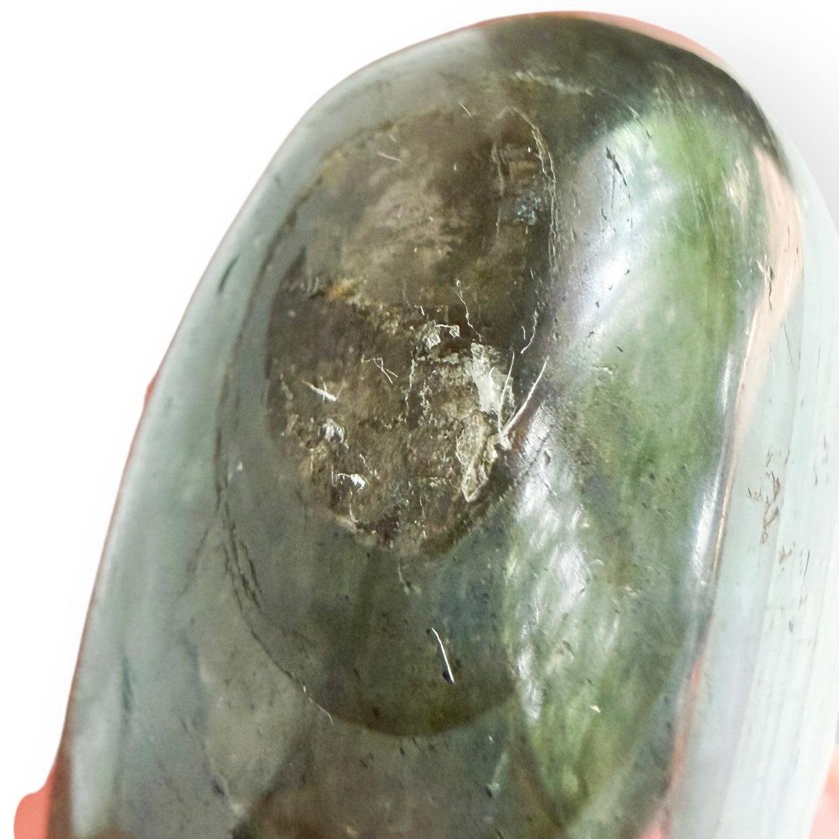 Close-up of a natural inclusion and surface detail on a polished Labradorite free form.